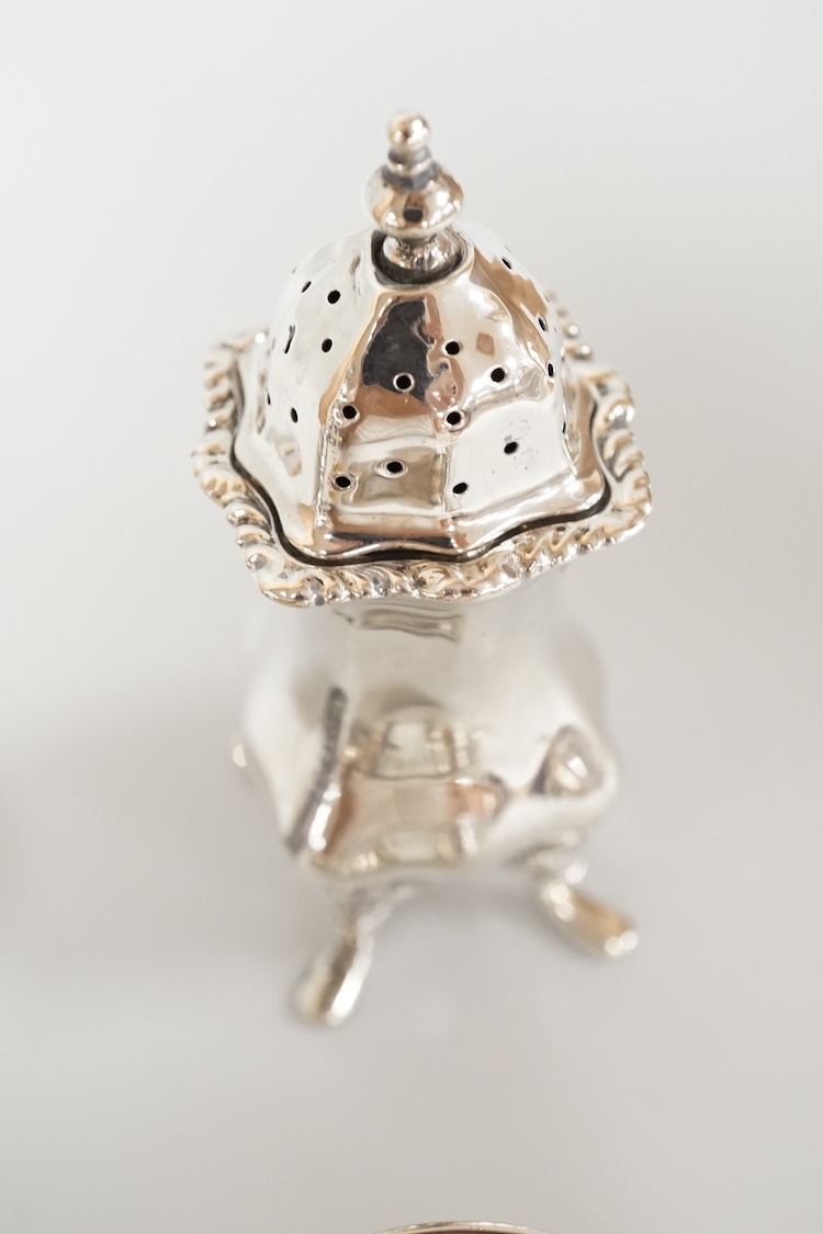 Four assorted silver condiments including a Victorian bun salt and a late Victorian pepper mill, together with a small silver bowl, a silver matchbox sleeve and a small silver two handled cup.